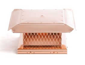 Close-up of a polished copper chimney cap with mesh sides, providing rain and wind protection while adding a luxurious finish.